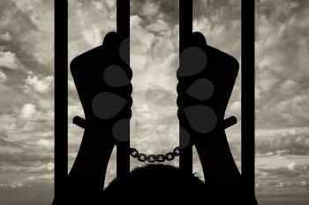 Freedom concept. Silhouette of human hands in handcuffs against the sky
