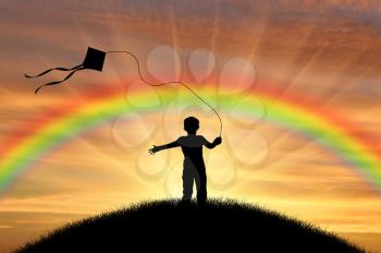 Silhouette child playing with kite on street sunset and rainbow. Concept childhood and happiness