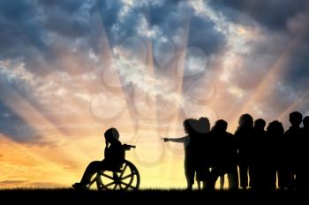 Disabled child in a wheelchair crying and children chased him sunset. Concept disabled child