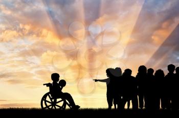 Disabled child in a wheelchair with a ball and the children do not want to play with him. Children with disabilities concept