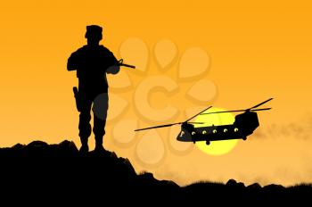 Silhouette of a soldier and helicopter at sunset