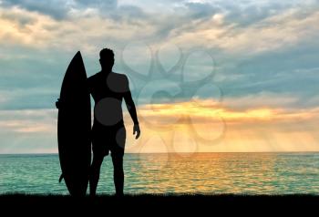 Concept of sport. Surfers silhouette against the sea in the evening
