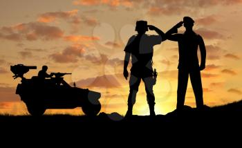 Silhouette of a soldier and the commander of a combat vehicle Humvee at sunset