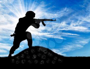 Concept of a terrorist. Silhouette of a terrorist attack gunman with a rifle and the land of skulls