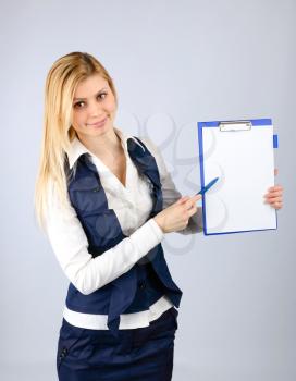 Concept of a contract. Business woman in a suit holding a pen and tablet