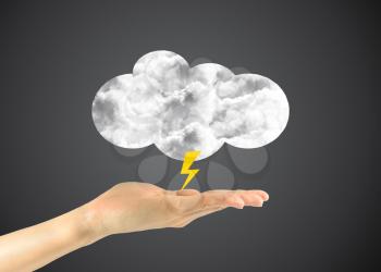 Concept of the weather forecast. Icon clouds with a lightning in a man's hand