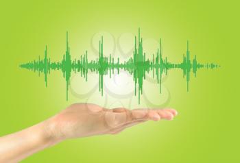 Concept of music and radio. Musical waves in a man's hand