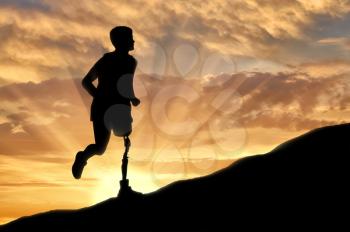 Concept of disability. Man with prosthetic leg running up the hill