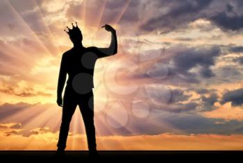 A silhouette of a narcissistic man with a crown on his head shows his finger on himself. He tries to attract attention. The concept of narcissism and selfishness