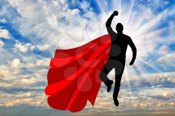 Superman businessman superhero. Silhouette of a businessman in the image of a superman flying in the sky