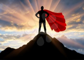 Superman businessman superhero. Silhouette of a confident and strong superman businessman on top of a mountain at sunset