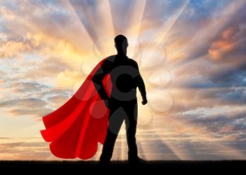 Superman businessman superhero. Silhouette of confident and strong businessman superman at sunset