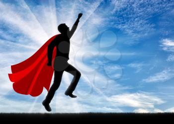 Superman businessman superhero. Silhouette of a businessman in the image of a superman takes off into the sky