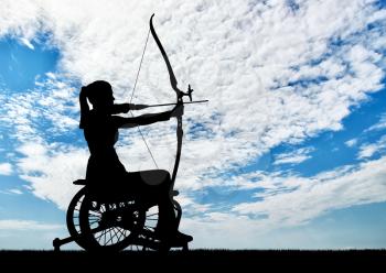 Silhouette of a disabled woman in a wheelchair engaged in sports archery. Concept of people with disabilities in sports