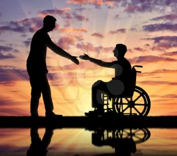 A man is about to shake hands with a disabled man in a wheelchair. The concept of respect and assistance to people with disabilities in society