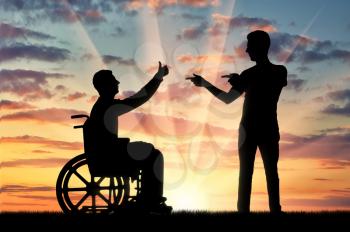 Happy disabled person in a wheelchair at sunset and comrade who supports it. The concept of persons with disabilities in society
