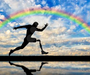 Running a disabled person with a prosthetic leg, confidently running on the ground and rainbow on a background of clouds and rainbows