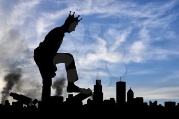 Silhouette of a man selfish giant with a crown on his head, destroys the city on your way - it does not stop. The concept of a large ego - a social problem