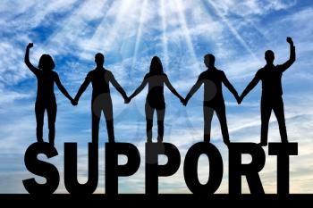 Silhouette of a group of happy people of five people holding hands while standing on a word of support. The concept of mutual assistance