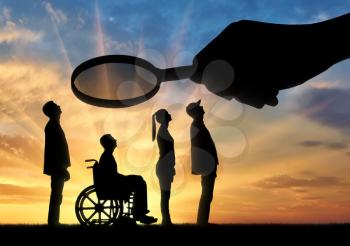 Employer's hand looks through the magnifying glass to an invalid in a wheelchair waiting for an interview for work. Concept of discrimination and inequality of people with disabilities