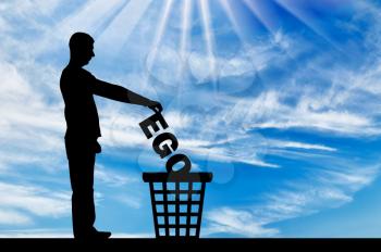Silhouette of a man throws the word ego into the garbage bin. The concept of selfishness as a bad habit from which it is necessary to refuse