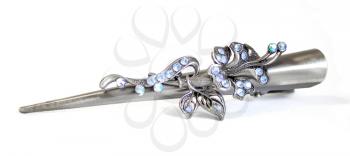 Classical barrette with flowers and blue crystals, is isolated on a white background.