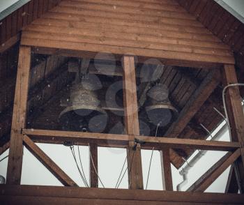 Russian church bells in the temple of the icon of the Mother of God Tikhvinskaya in the village of Brusovo, Russia. Photo toned. Art photo. Added grain.