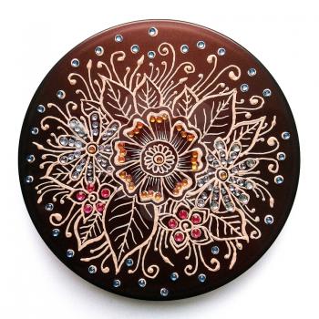 Round composition of flowers. Painting mehendi with acrylic paints. Decorated with rhinestones.