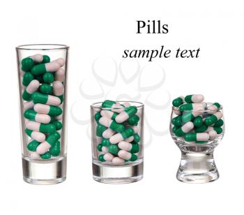 A glass of pills and capsules on white background(with sample text)