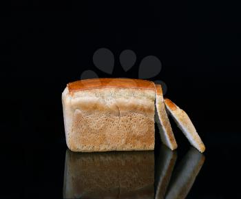 Bread on a black background with reflection