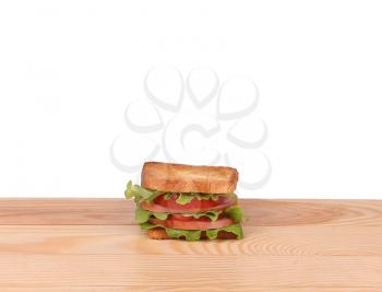 big sandwich with fresh vegetables on wooden board on white background