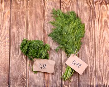 Different fresh herbs on wooden background