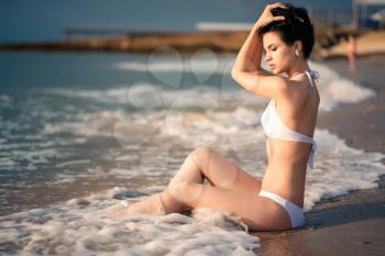 The beautiful girl in bikini on a beach. tropic island girl on vacation.