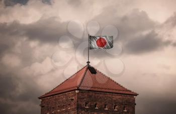 Flag with original proportions. Flag of the Japan. beautiful flailing flag on the roof of the old fortress
