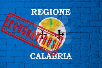 Flag of the regions of Italy Calabria with original proportions. stamped of Coronavirus. brick wall texture. Corona virus concept. On the verge of a COVID-19 or 2019-nCoV Pandemic.