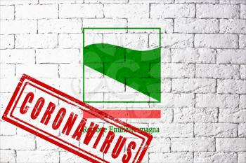 Flag of the regions of Italy Emilia Romagna with original proportions. stamped of Coronavirus. brick wall texture. Corona virus concept. On the verge of a COVID-19 or 2019-nCoV Pandemic.