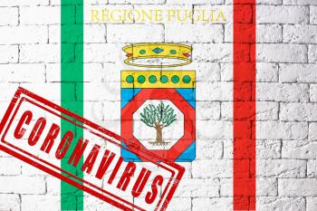 Flag of the regions of Italy Puglia with original proportions. stamped of Coronavirus. brick wall texture. Corona virus concept. On the verge of a COVID-19 or 2019-nCoV Pandemic.
