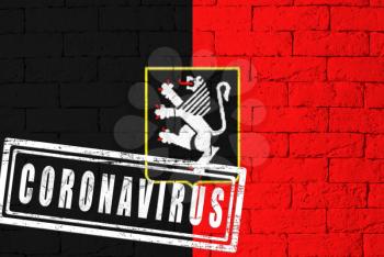 Flag of the regions of Italy Valle d'Aosta with original proportions. stamped of Coronavirus. brick wall texture. Corona virus concept. On the verge of a COVID-19 or 2019-nCoV Pandemic.