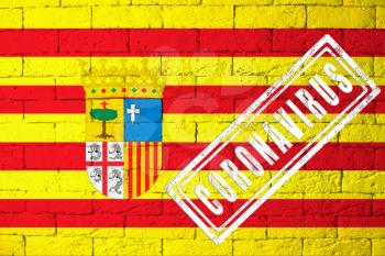 Flag of the regions or communities of Spain Aragon with original proportions. stamped of Coronavirus. brick wall texture. Corona virus concept. On the verge of a COVID-19 or 2019-nCoV Pandemic.