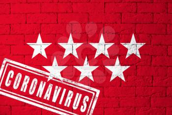 Flag of the regions or communities of Spain Madrid with original proportions. stamped of Coronavirus. brick wall texture. Corona virus concept. On the verge of a COVID-19 or 2019-nCoV Pandemic.