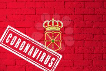 Flag of the regions or communities of Spain Navarra with original proportions. stamped of Coronavirus. brick wall texture. Corona virus concept. On the verge of a COVID-19 or 2019-nCoV Pandemic.