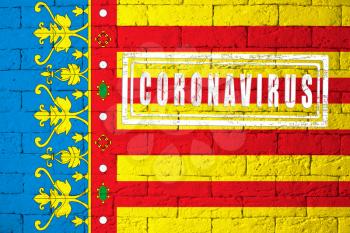 Flag of the regions or communities of Spain Valencia with original proportions. stamped of Coronavirus. brick wall texture. Corona virus concept. On the verge of a COVID-19 or 2019-nCoV Pandemic.