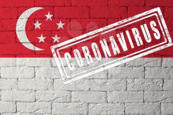Flag of the Singapore with original proportions. stamped of Coronavirus. brick wall texture. Corona virus concept. On the verge of a COVID-19 or 2019-nCoV Pandemic.