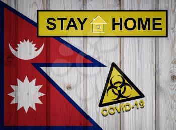 Flag of the Nepal in original proportions. Quarantine and isolation - Stay at home. flag with biohazard symbol and inscription COVID-19.