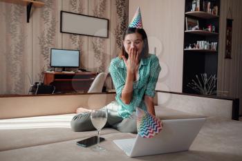 Girl celebrating birthday online in quarantine time through video call virtual party. Coronavirus outbreak 2020. Woman have positive emotions.