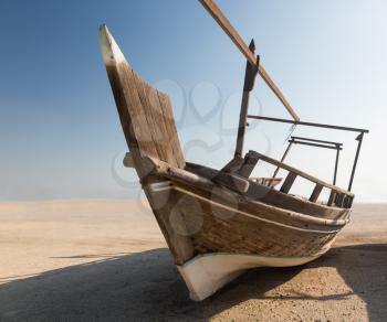 Fishing or fisherman boat or dhow isolated in desert with no sign of the ocean in Bahrain, Middle East