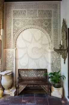 Ornate carved moorish bench and alcove in courtyard in Jewish quarter of Cordoba, Spain, Europe