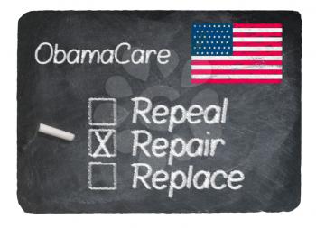 Obamacare health plan choice of repair written in chalk on a chalky natural slate blackboard