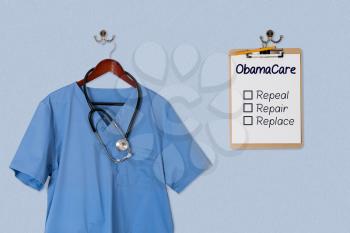 Blue medical scrubs uniform shirt hanging on a hanger with stethoscope with Obamacare options on clipboard