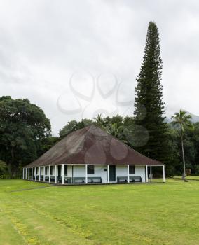The old Waioli Huiia Mission building and hall in Hanalei Kauai with the Na Pali Mountains shrouded in mist in the background